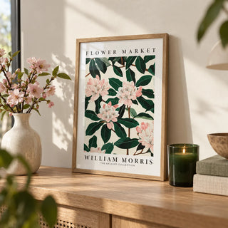 Magnolia Wall Art, a small A4 framed print leaning on an oak shelf in a living room