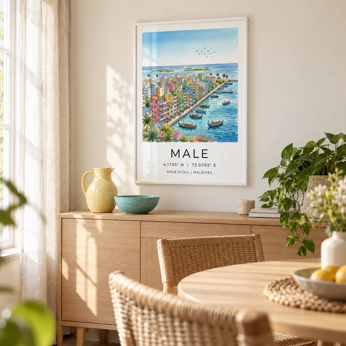 Maldives City Art Print, framed on the wall of a bright dining corner in a UK first home with a pale cream wall and simple woven dining chairs