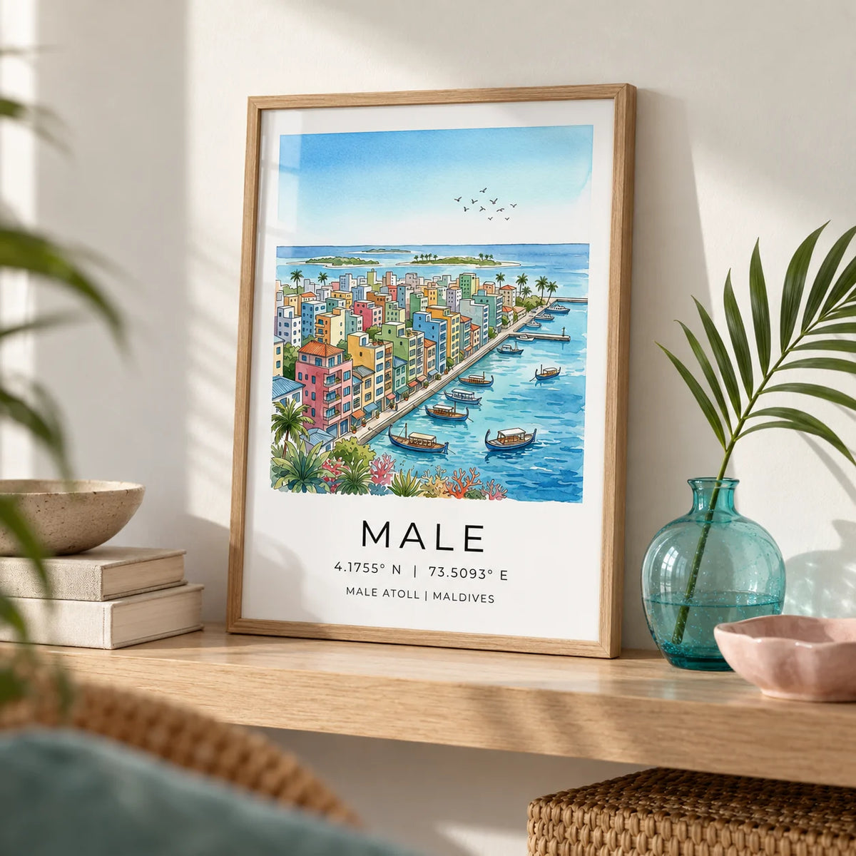 Maldives City Art Print, a small A4 framed print leaning on a pale oak shelf in a living room