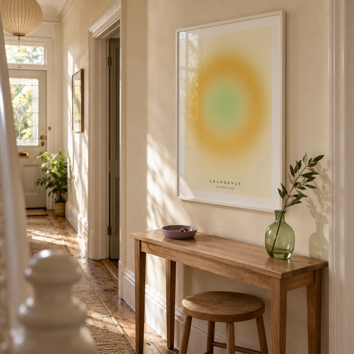 Manifestation Wall Art, framed on the wall of a welcoming narrow hallway in a Victorian UK terrace with pale cream walls and warm timber floorboards