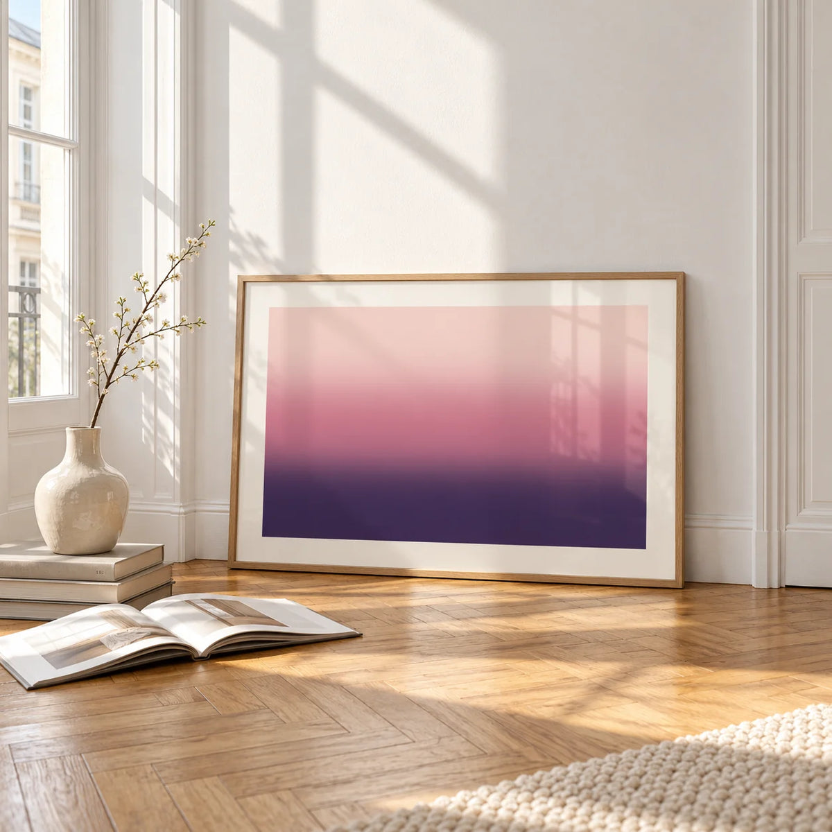 Mauve Print, framed and leaning on the parquet floor of a bright living room