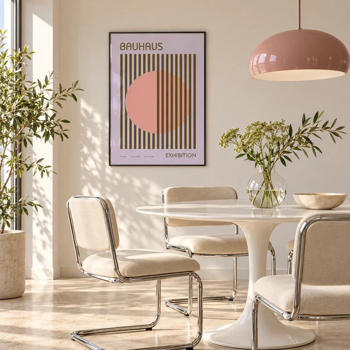 MCM Wall Art, framed on the wall of a bright dining room with a pink pendant and chrome chairs