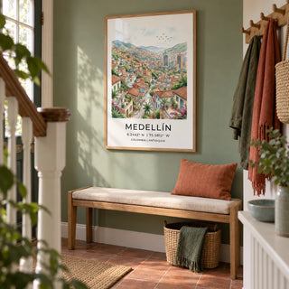 Medellin City Art Print, framed on the wall of a welcoming hallway in a UK terraced house with a muted leafy green wall and simple terracotta floor tiles
