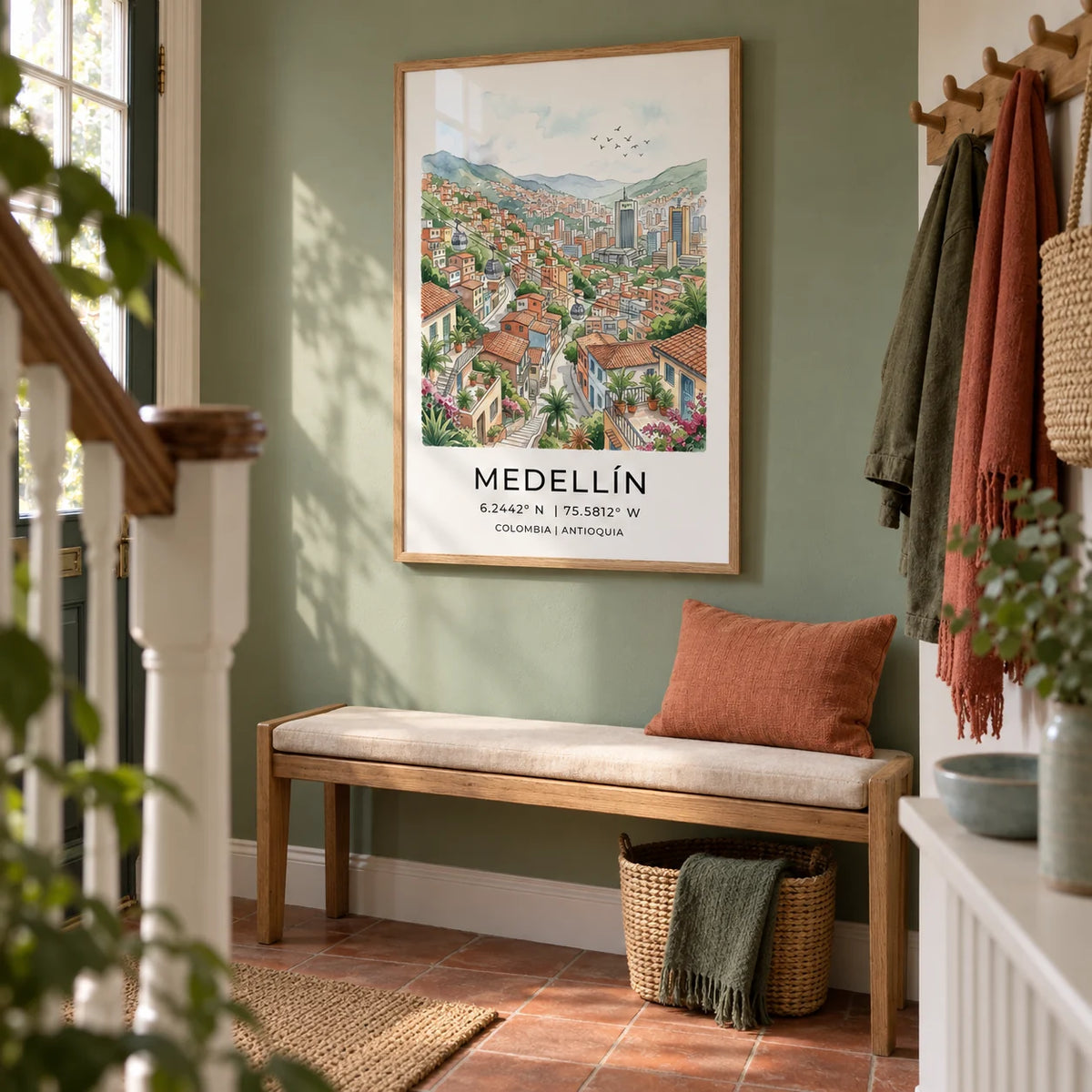 Medellin City Art Print, framed on the wall of a welcoming hallway in a UK terraced house with a muted leafy green wall and simple terracotta floor tiles