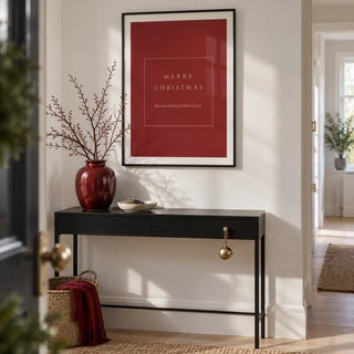 Merry Christmas Poster, framed on the wall of a crisp entrance hallway in a modern UK flat with white walls and pale oak floorboards