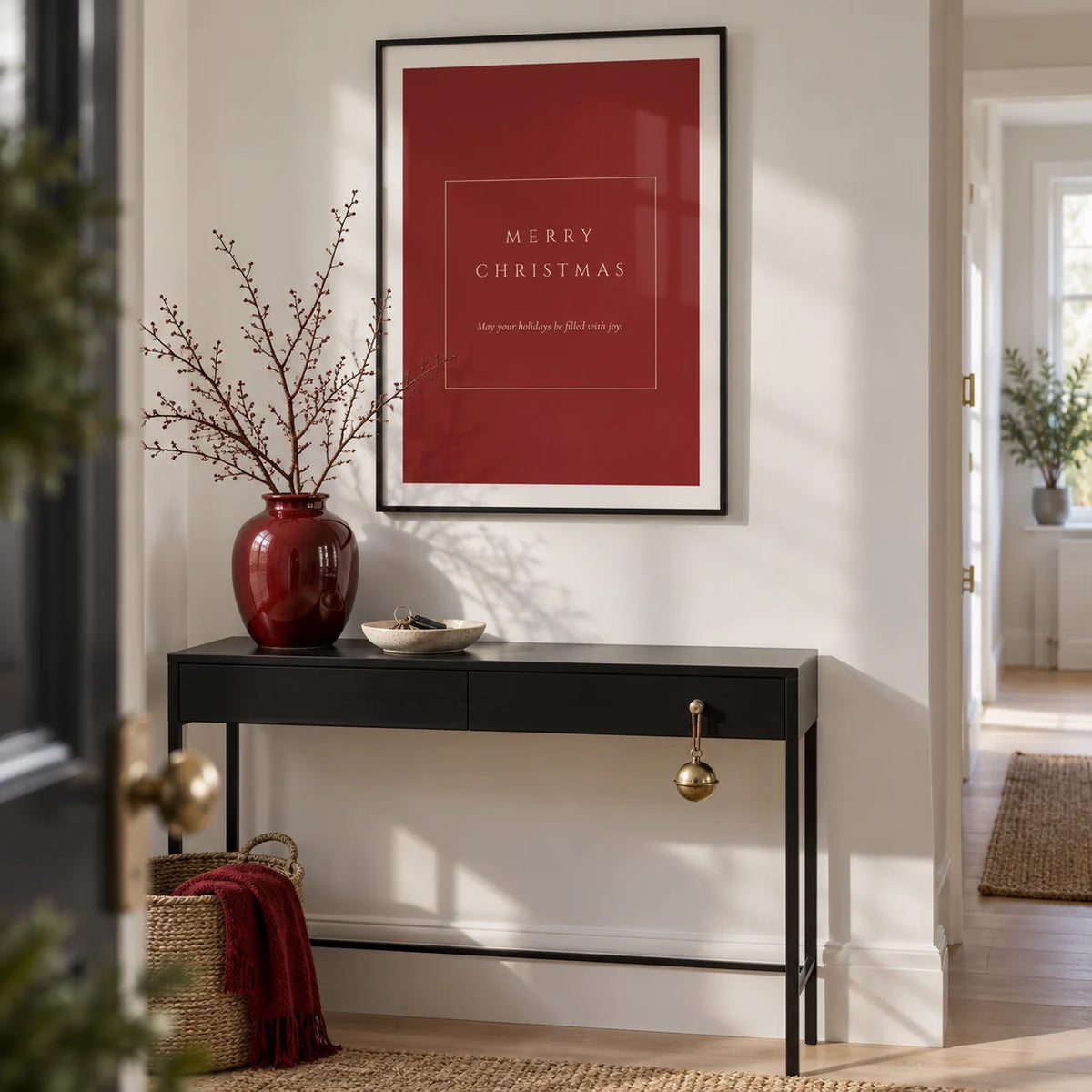 Merry Christmas Poster, framed on the wall of a crisp entrance hallway in a modern UK flat with white walls and pale oak floorboards