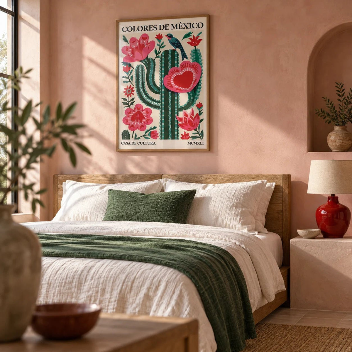 Mexican Folk Art Cactus, framed on the wall of a calm Mexican-modern bedroom with a soft pink limewashed wall and an arched plaster niche