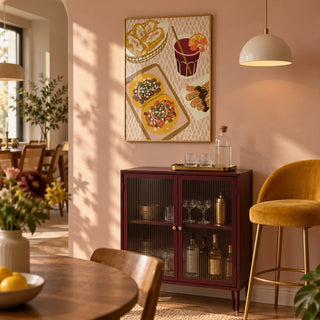 Mexican Food Art Print, framed on the wall of a small home bar corner within an open-plan dining room with a muted blush wall and a slim burgundy drinks cabinet