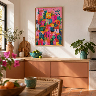Mexican Village Painting, framed on the wall of a warm Mexican-modern kitchen with a terracotta floor and plain white plaster walls