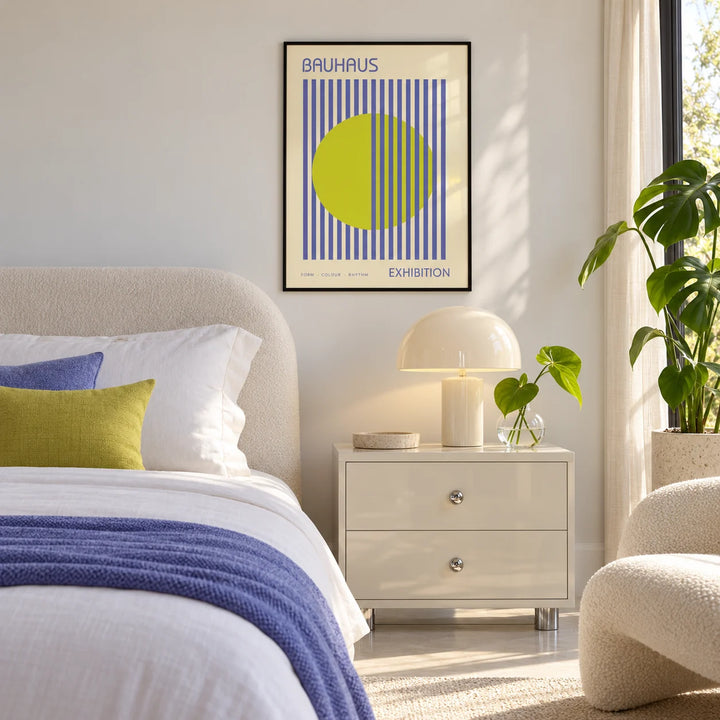 Mid Century Modern Art, framed on the wall of a calm white bedroom with a periwinkle throw and lime cushion