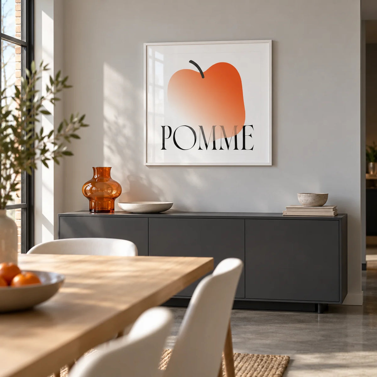 Minimalist Apple Art Print, framed on the wall of a modern open-plan dining space in a UK flat with a pale grey wall and a polished concrete floor