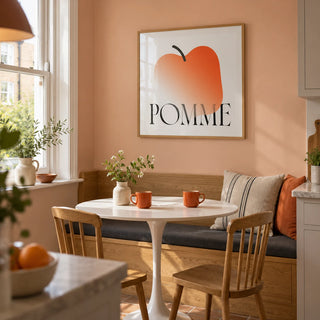 Minimalist Apple Art Print, framed on the wall of a small kitchen breakfast nook in a UK maisonette with a peach painted wall and a built-in oak banquette