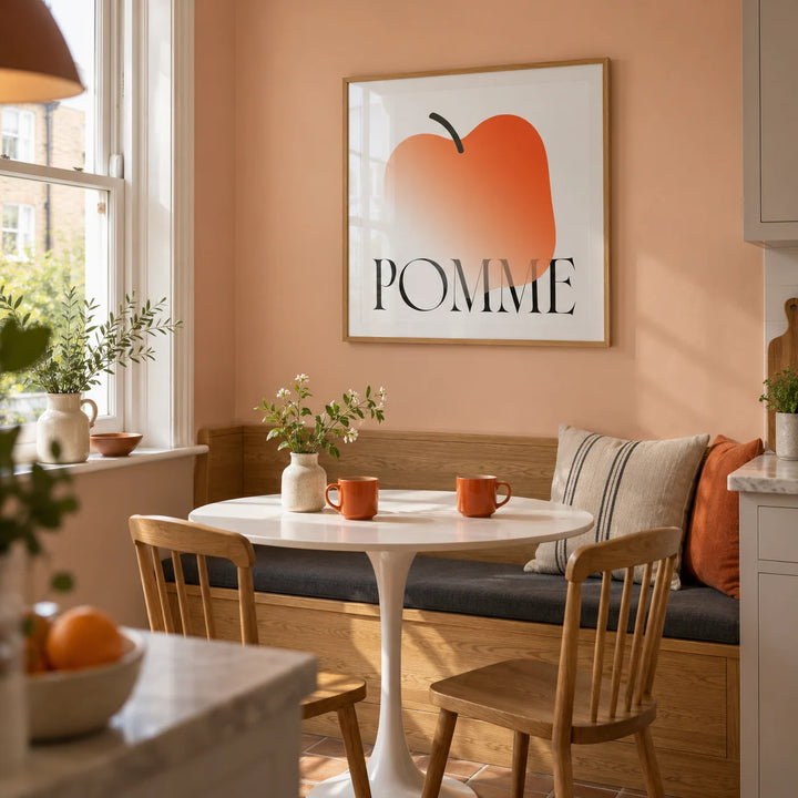Minimalist Apple Art Print, framed on the wall of a small kitchen breakfast nook in a UK maisonette with a peach painted wall and a built-in oak banquette
