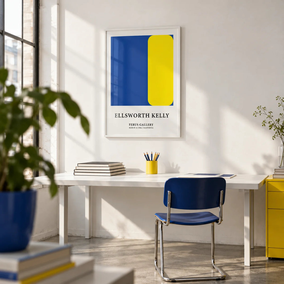 Minimalist Art Prints, framed on the wall of a bright design studio with a white wall and a concrete floor in a home office