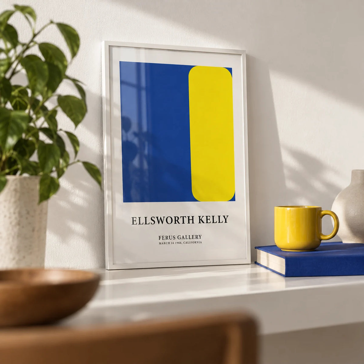 Minimalist Art Prints, a small A4 framed print leaning on a white shelf in a living room