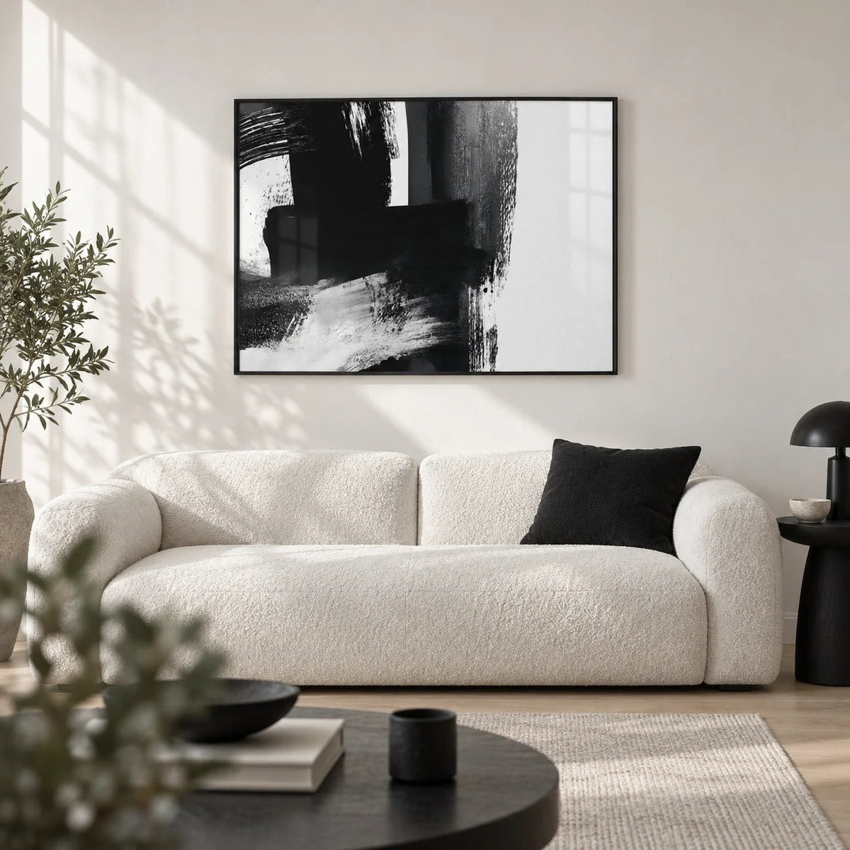 Minimalist Black And White Print, framed on the wall of a crisp monochrome living room with a white wall and a pale oak floor