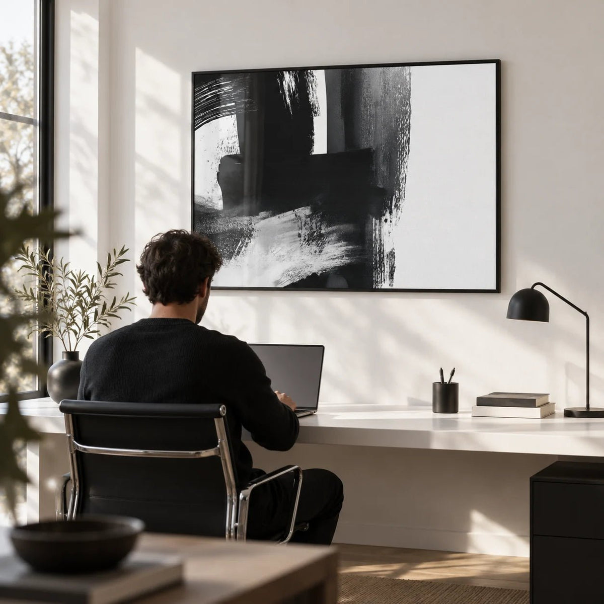 Minimalist Black And White Print, framed on the wall of a minimal home office with a white wall