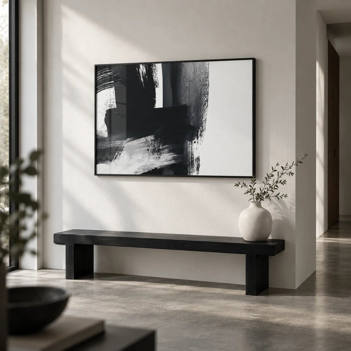 Minimalist Black And White Print, framed on the wall of a modern hallway with a white wall and a concrete floor