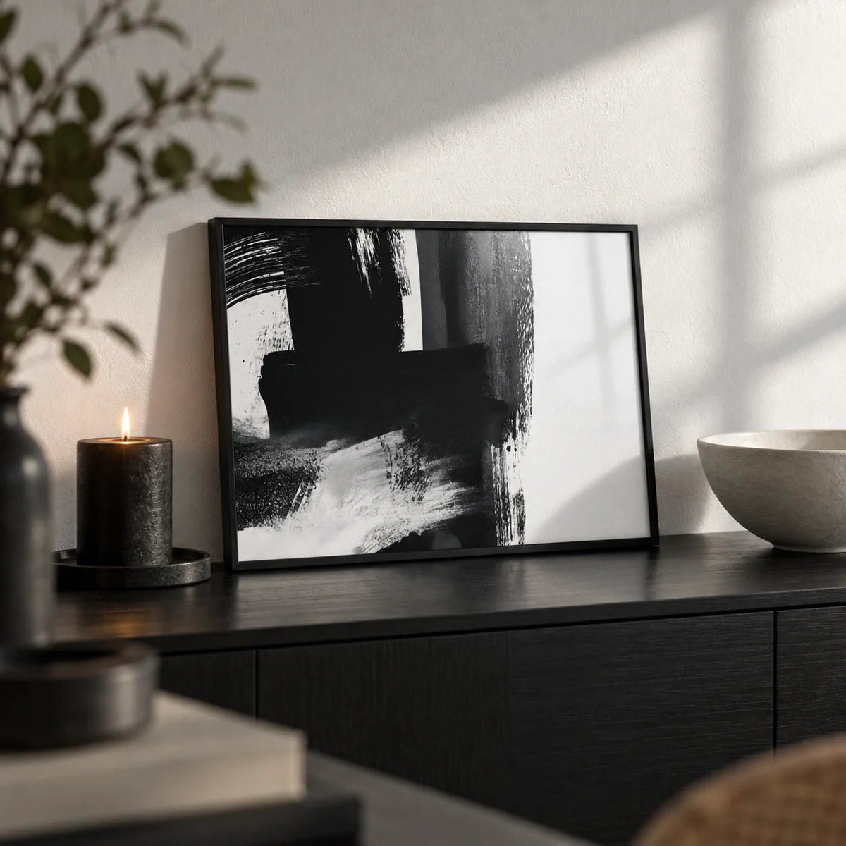 Minimalist Black And White Print, a small A4 framed print leaning on a black sideboard in a living room