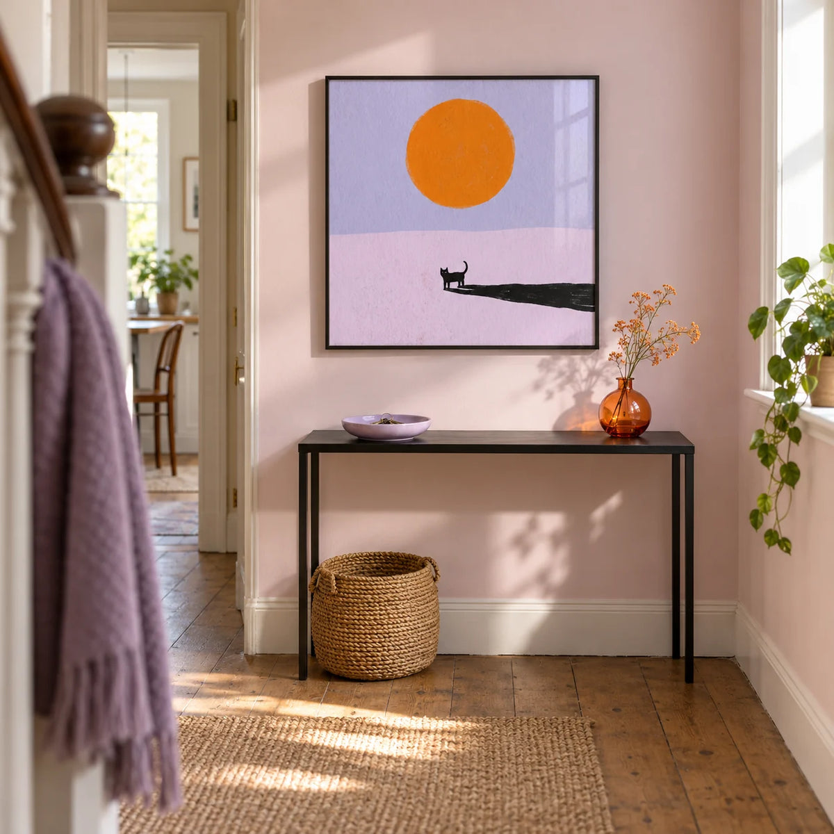 Minimalist Cat Art Print, framed on the wall of a bright narrow hallway in a renovated UK terrace with a pale pink wall and timber floor