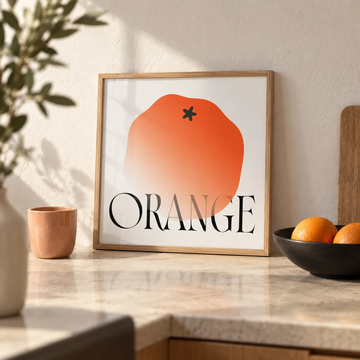 Minimalist Fruit Wall Art, a small A4 framed print leaning on a pale stone kitchen worktop