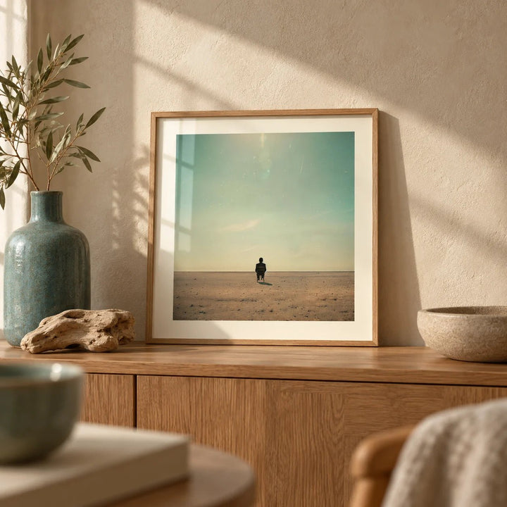 Minimalist Surrealism Art, a small A4 framed print leaning on an oak sideboard in a living room