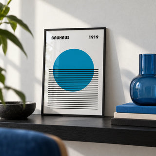 Minimlist Art, a small A4 framed print leaning on a black shelf in a living room