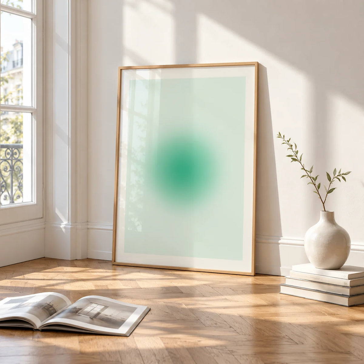 Mint Print, framed and leaning on the parquet floor of a bright living room