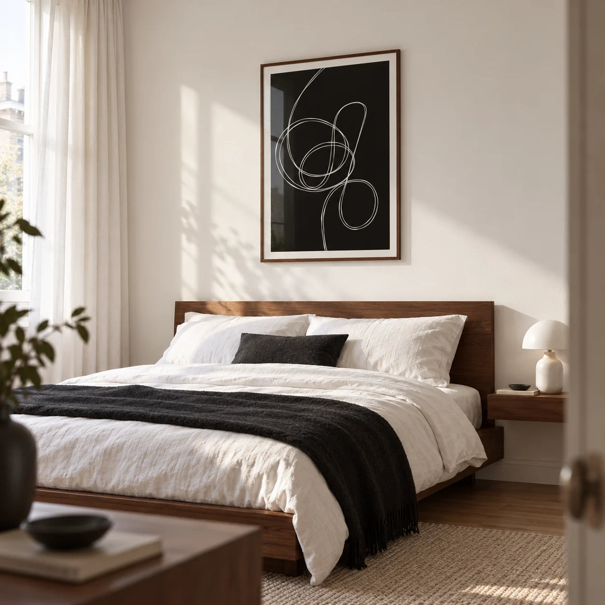 Modern Black And White Art, framed on the wall of a contemporary bedroom in a renovated UK terrace with a soft white wall and walnut furniture