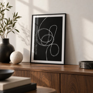Modern Black And White Art, a small A4 framed print leaning on a walnut sideboard in a living room