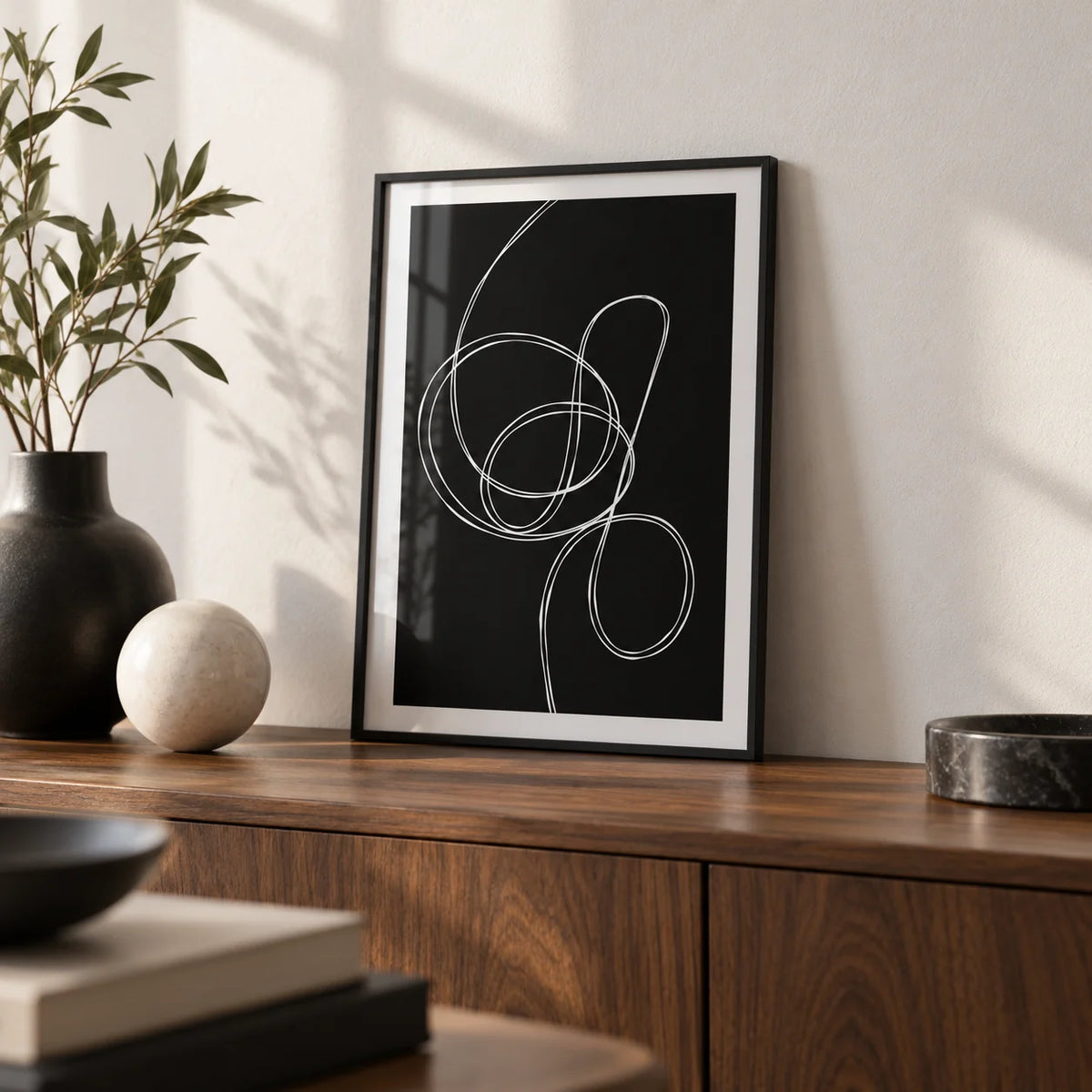 Modern Black And White Art, a small A4 framed print leaning on a walnut sideboard in a living room