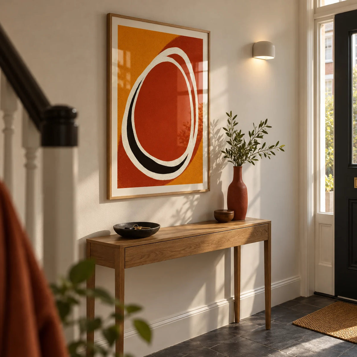 Modern Minimalist Art Print, framed on the wall of a narrow entrance hallway in a modernised UK terrace with off-white walls and a charcoal stone floor