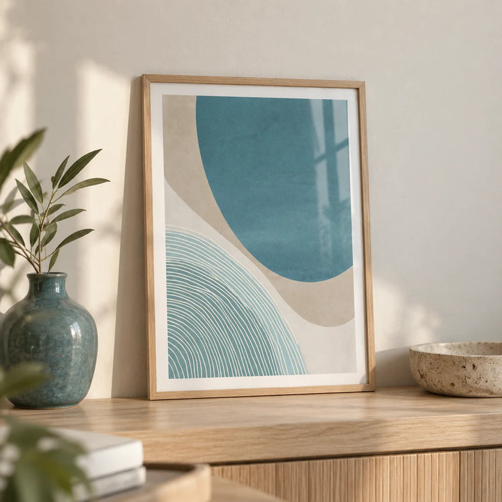 Modern Minimalist Print, a small A4 framed print leaning on a pale oak shelf in a living room