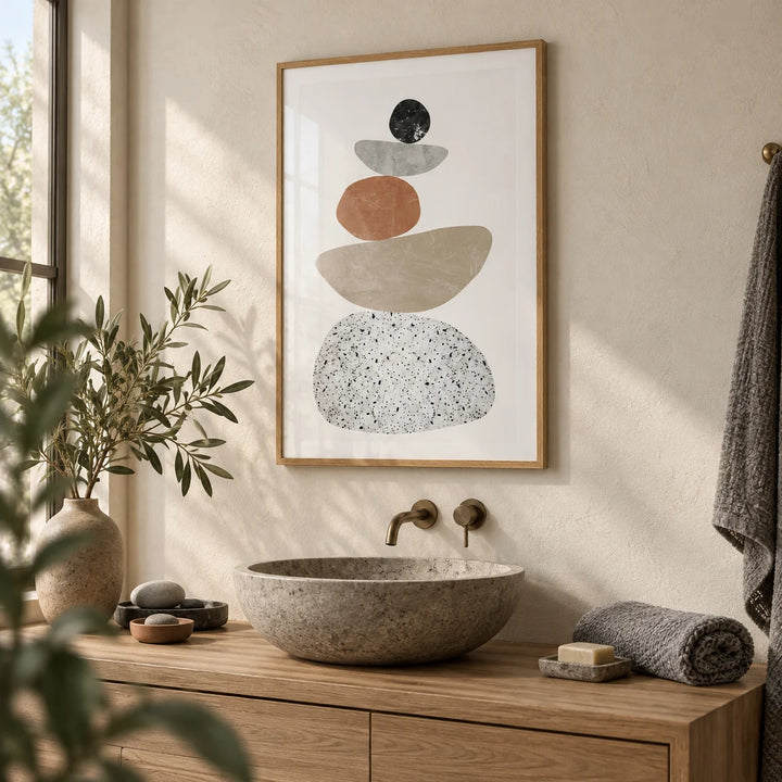 Modern Pebble Print, framed on the wall of a calm spa bathroom with a warm white plaster wall