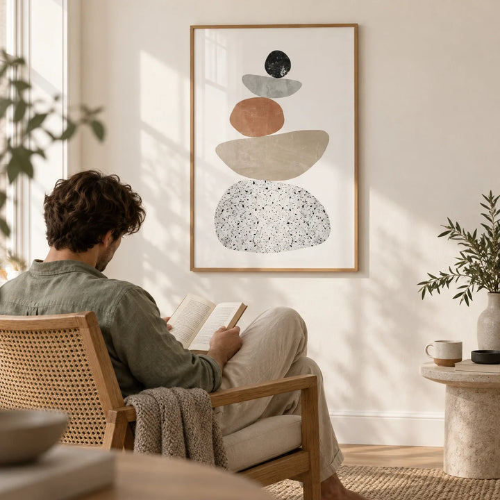 Modern Pebble Print, framed on the wall of a quiet reading corner with a warm white wall in a living room