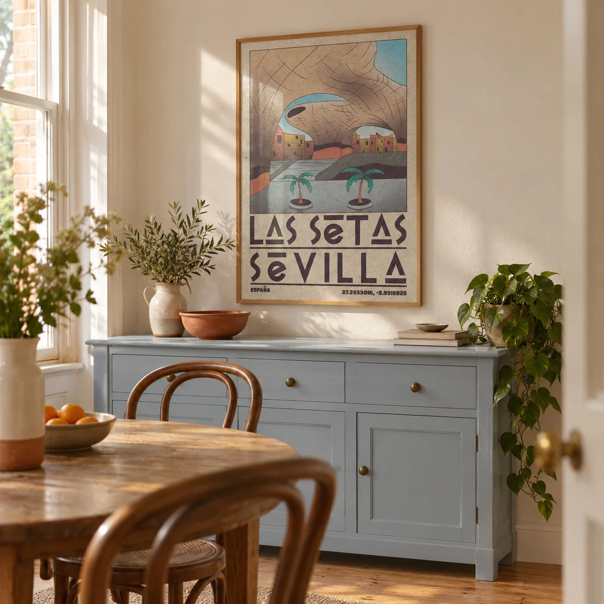 Modern Sevilla Wall Art, framed on the wall of a characterful dining room in a UK terraced house with warm white walls and a pale blue painted sideboard
