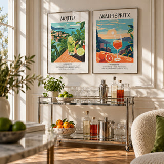 Mojito and Spritz Prints Set of 2 styled above a chrome bar cart with cocktail glasses: Mojito and Amalfi Spritz shown framed side by side (frames not included)