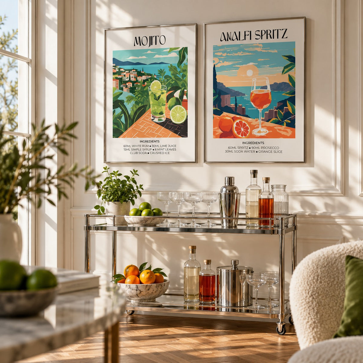Mojito and Spritz Prints Set of 2 styled above a chrome bar cart with cocktail glasses: Mojito and Amalfi Spritz shown framed side by side (frames not included)