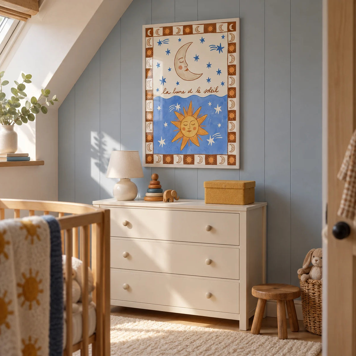 Moon And Sun Print, framed on the wall of a compact attic nursery in a UK semi-detached home with a sloping ceiling and a pale blue vertical end wall