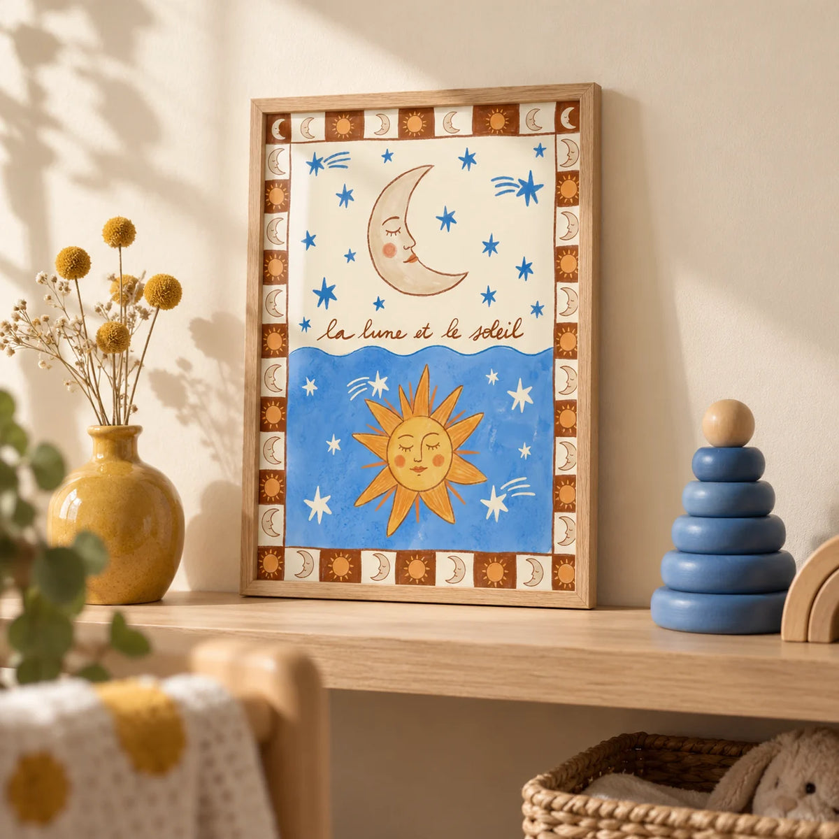 Moon And Sun Print, a small A4 framed print leaning on a pale oak nursery shelf
