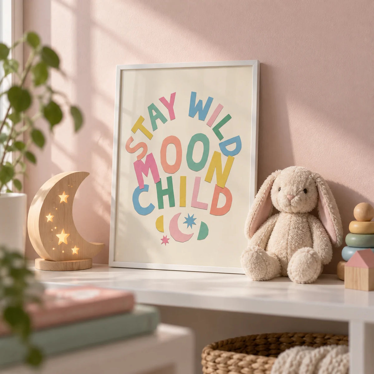 Moon Child Wall Art, a small A4 framed print leaning on a white nursery shelf