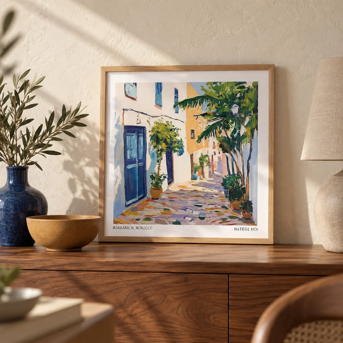 Morocco Wall Art, a small A4 framed print leaning on a walnut sideboard in a living room