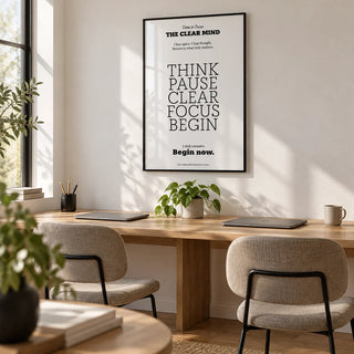 Motivational Art for the Office, framed on the wall of a small coworking space with a white wall and an oak floor