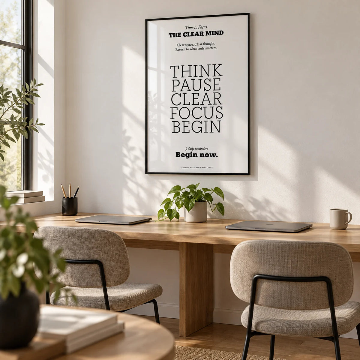Motivational Art for the Office, framed on the wall of a small coworking space with a white wall and an oak floor