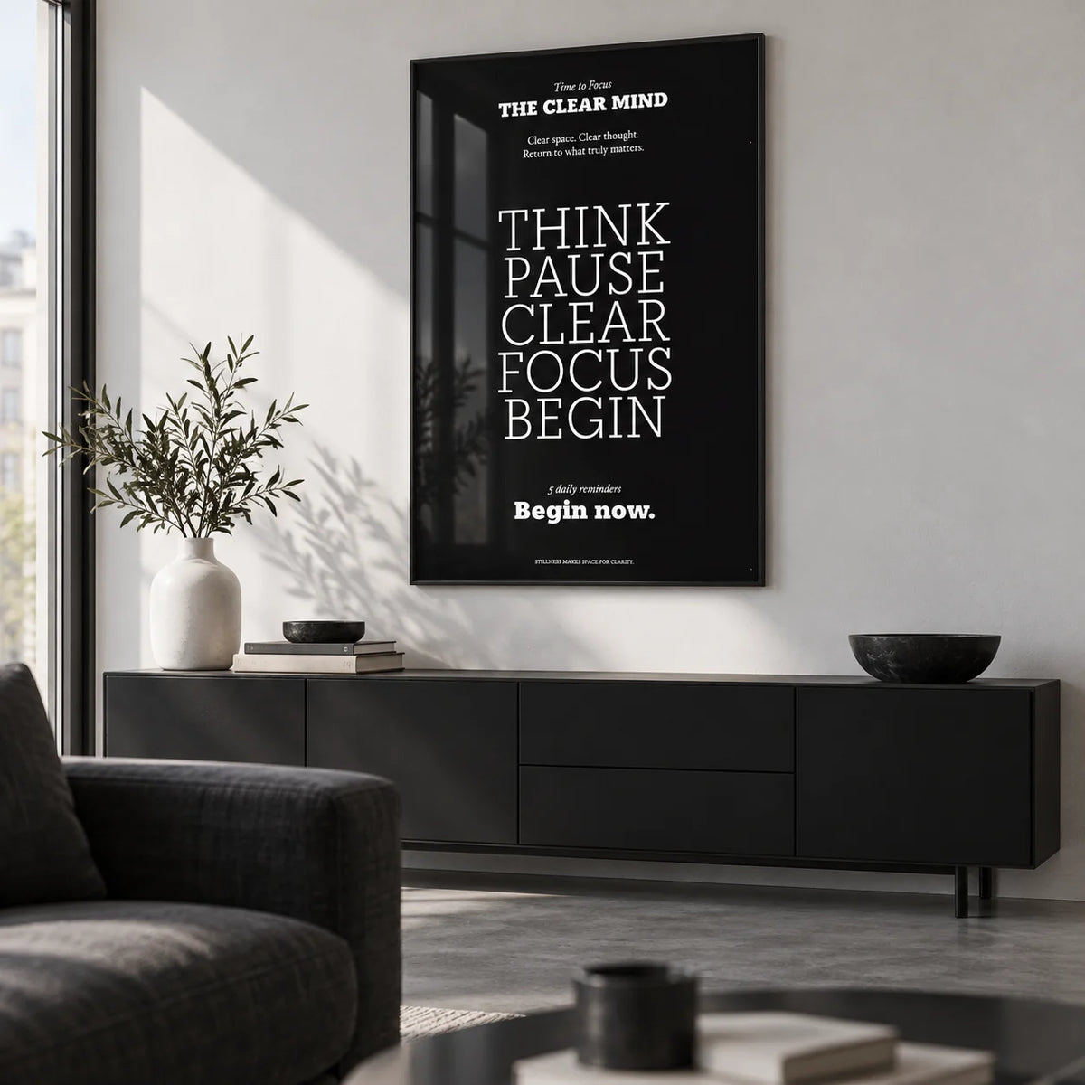 Motivational Quote Prints, framed on the wall of a monochrome city-flat living room with a white wall and a concrete floor