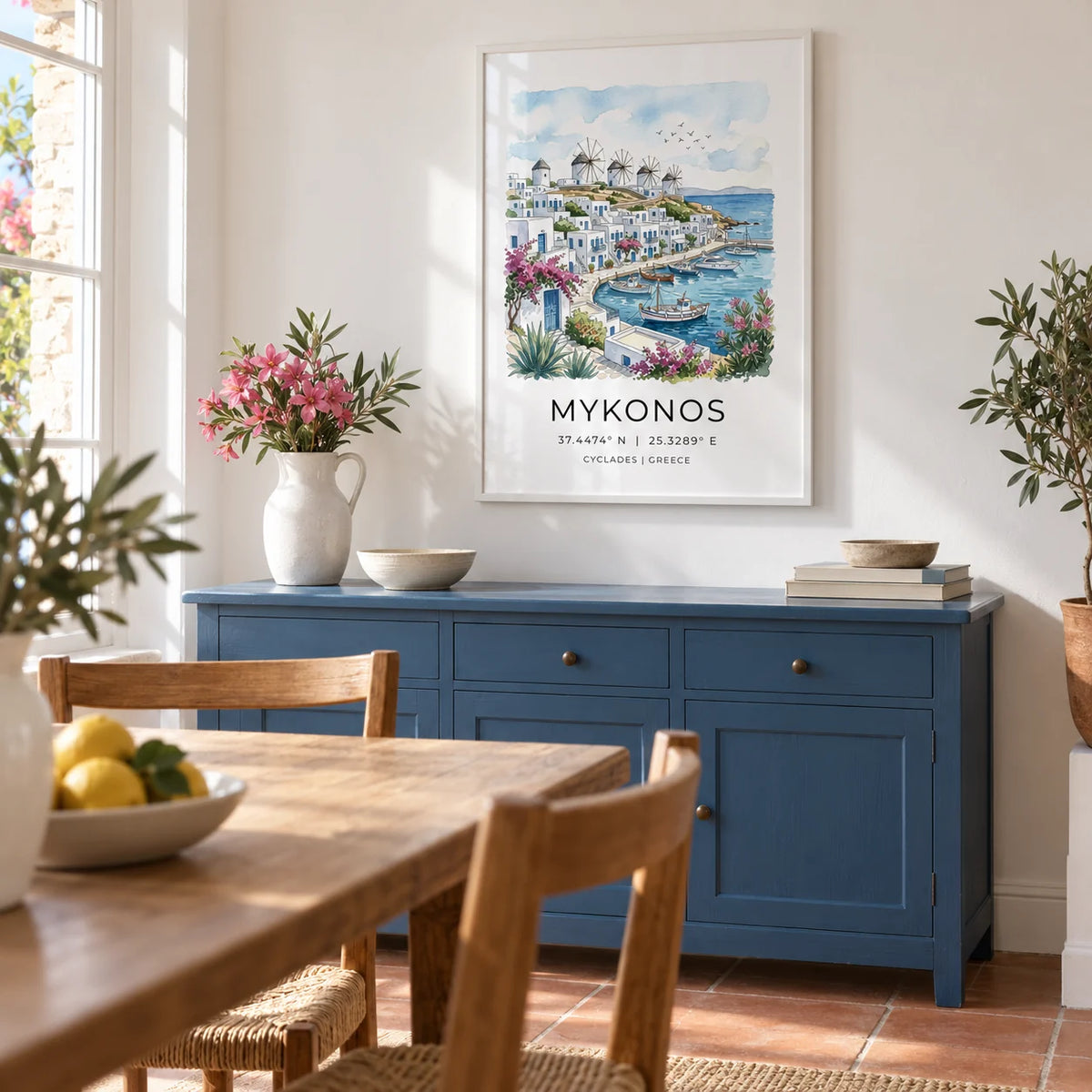 Mykonos Art Print, framed on the wall of a bright Mediterranean-inspired dining room in a UK family home with chalk-white walls and a simple terracotta floor