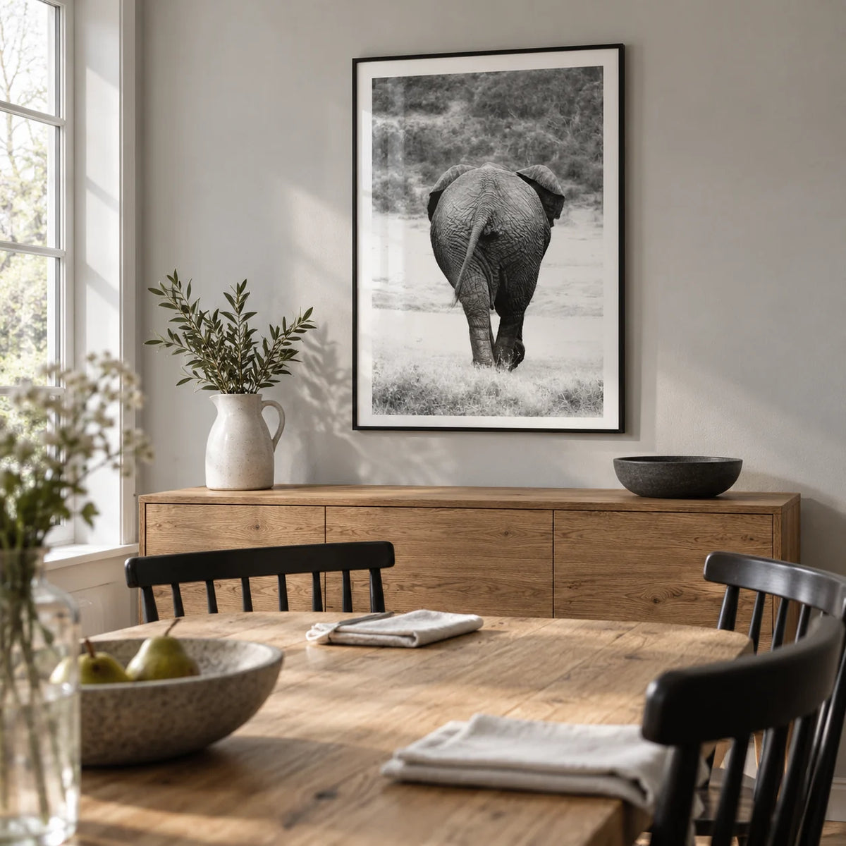 Nature Animal Wall Art, framed on the wall of a modest contemporary dining room in a UK family home with a pale grey wall and an oak table with black wooden chairs