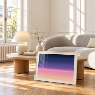 Navy and Pink Wall Art, framed and leaning against a coffee table in a bright living room