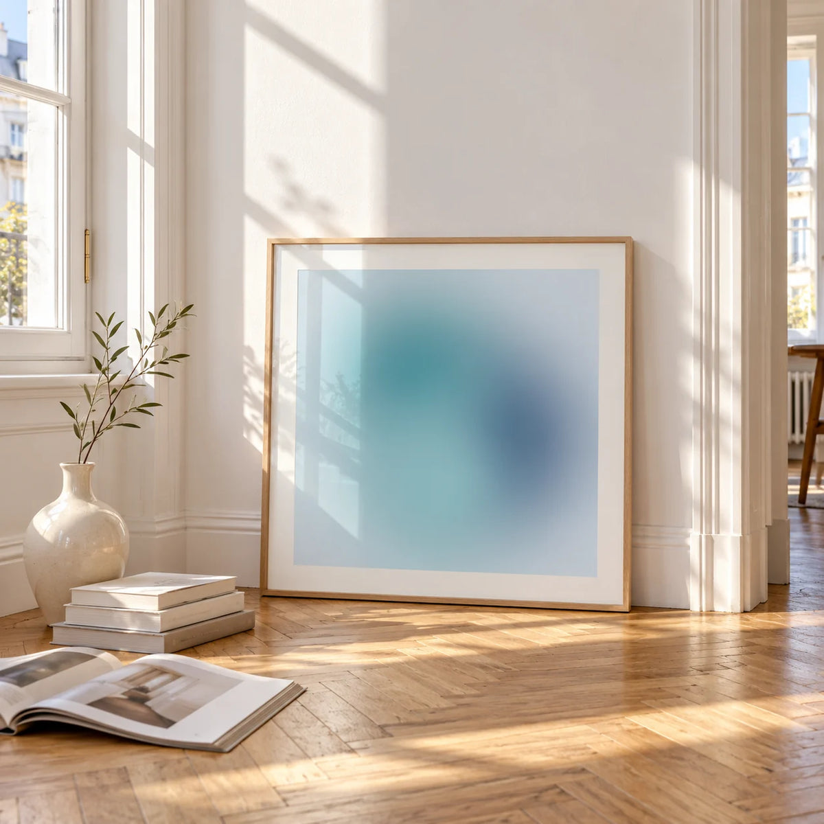 Navy Wall Art, framed and leaning on the parquet floor of a bright living room