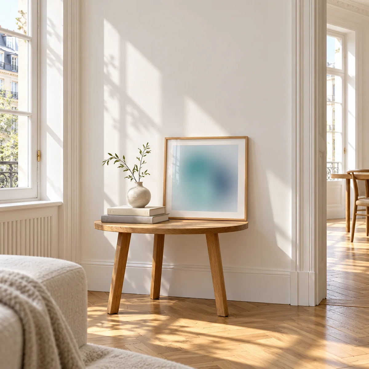 Navy Wall Art, a small square framed print leaning on a small solid oak side table